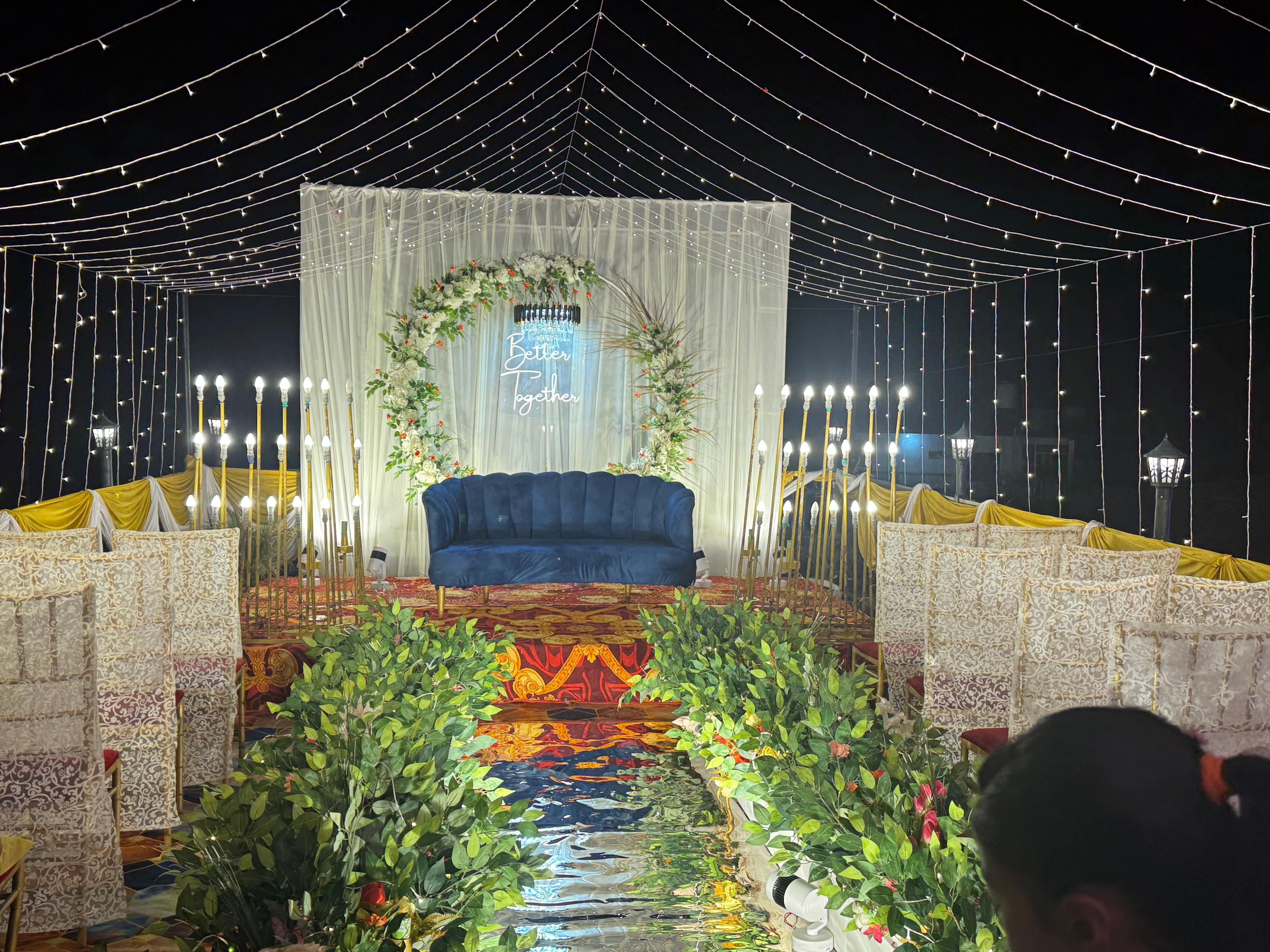 Wedding stage with floral arch and sofa